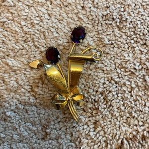 Sterling silver covered in  gold pin with purple jewels
